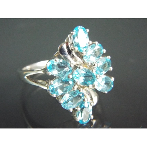 163 - Sterling Silver cluster ring with over 5cts of Brasillian Blue Topaz. With COA. Finger size 'S'