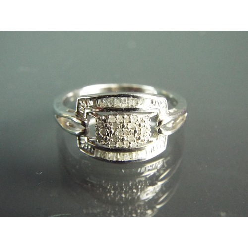 181 - Unusual Sterling silver ring set in a Buckle design containing 0.20pts of African White Diamonds. Wi... 