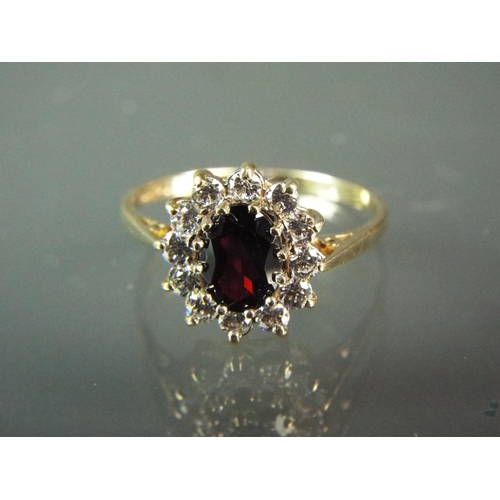 183 - 9ct Yellow Gold ring set with a large central Garnet surrounded by Cubic Zircona's.  Finger size 'S'... 