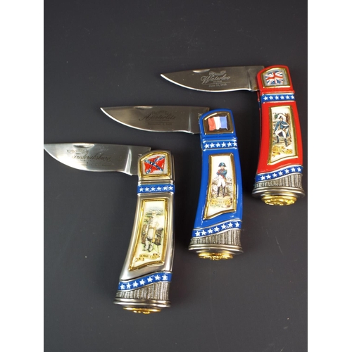 226 - Three Franklin mint collectable folding pocket knives with padded soft cases. As new condition.