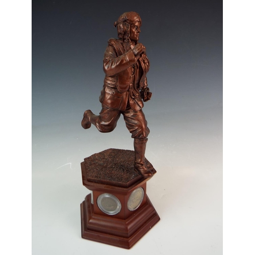 288 - Large Bronze effect resin sculpture of a Scrambling airman mounted on a wooden plinth set with coins... 