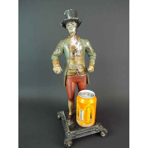 61 - 19th Century cold painted spelter figure of a man wearing frock coat and top hat. Raised on metal fo... 