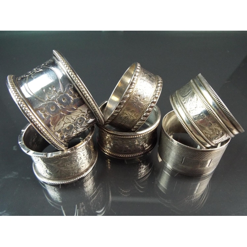 83 - Selection of Hallmarked silver napkin rings 1899-1915 era.    Plus one white metal napkin ring.