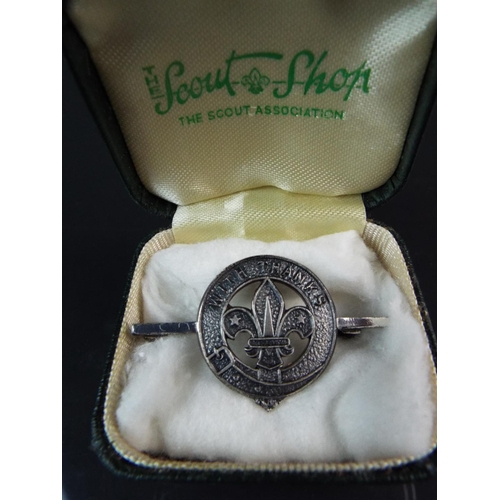 84 - Silver Napkin ring along with an interesting Silver scout badge in original presentation case.