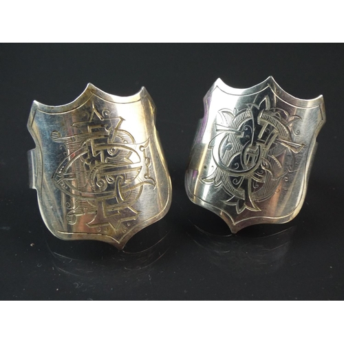 85 - Pair of hallmarked silver shield spring napkin rings. Beautifully engraved with family crest. 15.4g ... 