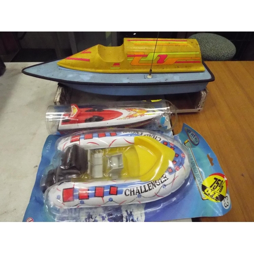 19 - Radio controlled powerboat with electric motor with wooden cradle 22 inches long, plus two other toy... 