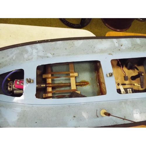 19 - Radio controlled powerboat with electric motor with wooden cradle 22 inches long, plus two other toy... 
