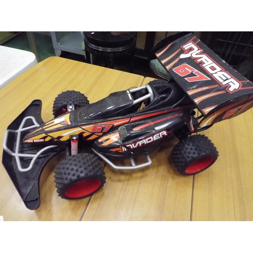 24 - Electric powered racing car, 20 inches long. Working condition unknown.