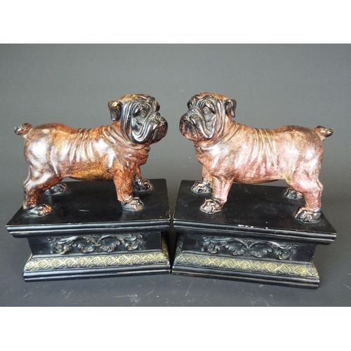 28 - Matched pair of Ceramic bulldogs mounted on ebonised and decorated wooden plinth bases. Each measure... 