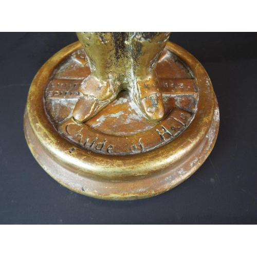 38 - Old Brass figure on circular base. 7 inches tall.