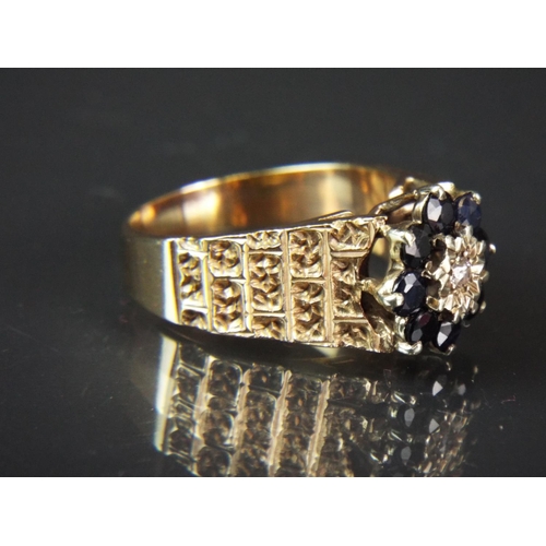 45 - 9ct Yellow gold ring set with single central Diamond with halo of eight sapphires, set on wide decor... 