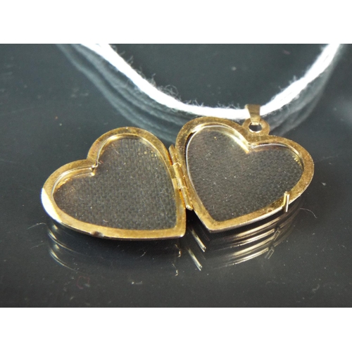 58 - 9ct Yellow gold heart shaped locket set with white gold decorations.  1.6g