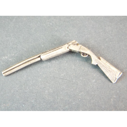 72 - Small white metal Shotgun model. Inscribed 'JS Brown, Number 33'  2 inches long.