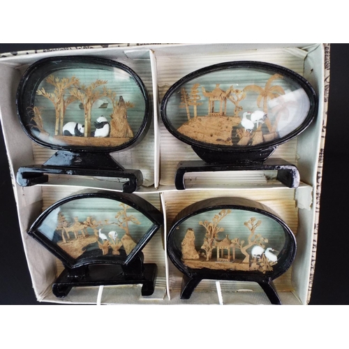 103 - Boxed set of four Chinese Diorama's. each one with glazed sides and ebonised wooden bases.