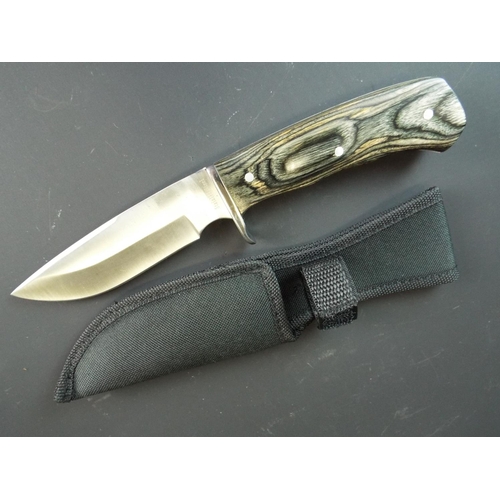 116 - As new hunters knife with Stainless steel blade and nylon scabbard. As new condition.