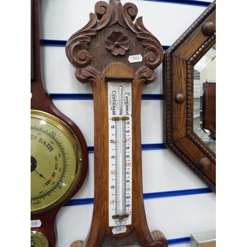 169 - Lovely old Aneroid barometer by Barnet of Hull on carved oak frame. Measuring  33 inches long