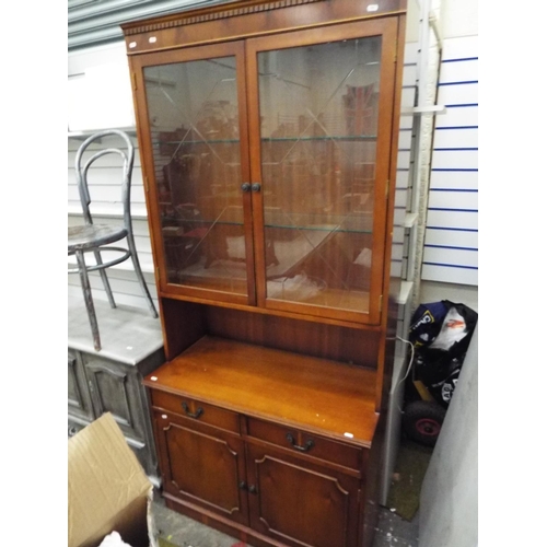 196 - Tall yew effect cupboard with glass door bookshelf above. H:78 X W:36 x D:17 inches.