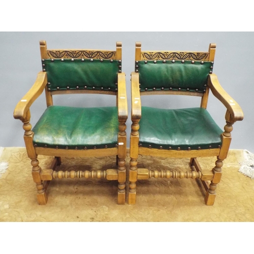 215 - Pair of oak carved chairs with leather seats and backrests.