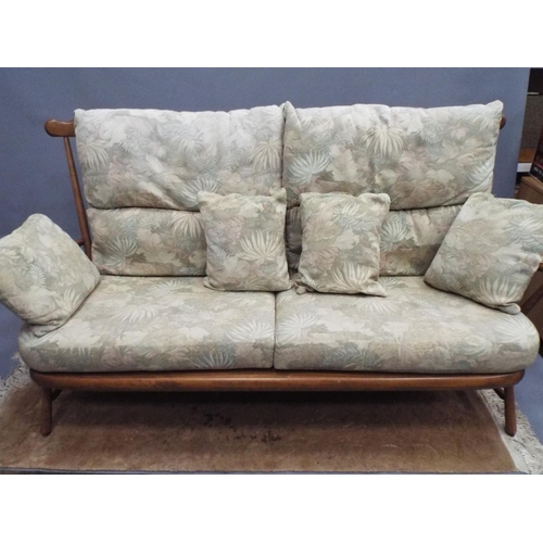 217 - Beautifully made stick back Ercol three seater settee in the 19140 pattern with fitted upholstered c... 