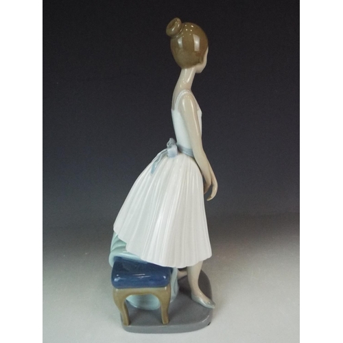 233 - Nao Standing ballerina with stool. 12 inches tall in perfect condition