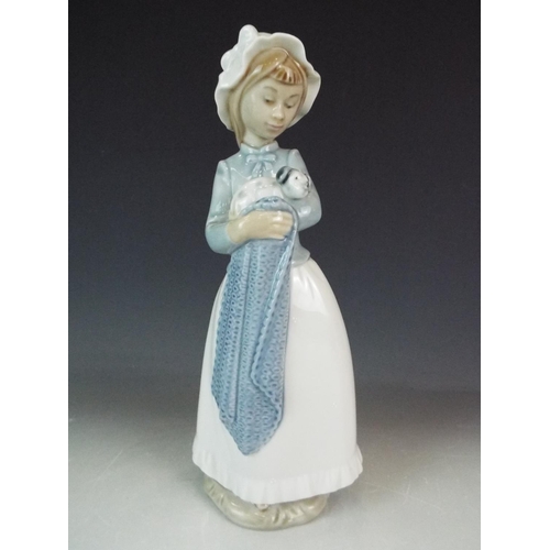 237 - Nao Figurine of a girl holding a puppy.  10.5 inches tall.