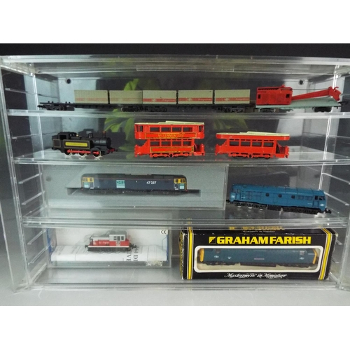 333 - Perspex model display cabinet together with motorised 000 gauge models, some boxed and unused.