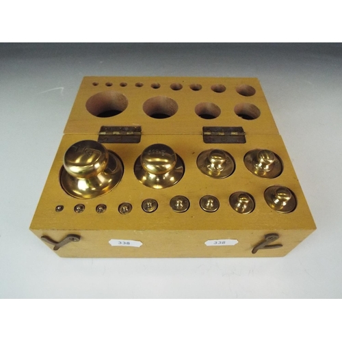 338 - Boxed set of brass scientific weights,