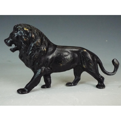 353 - Solid Bronze figure of an African Lion. 5 inches long.