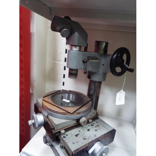 605 - Industrial microscope, solid metal and very heavy 18 inches tall.