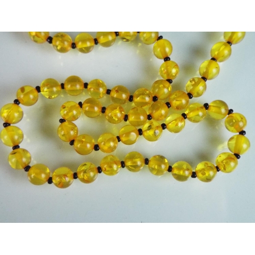 146 - 24 inch Amber bead necklace with a 9ct Yellow gold clasp. Each bead approx 6mm.