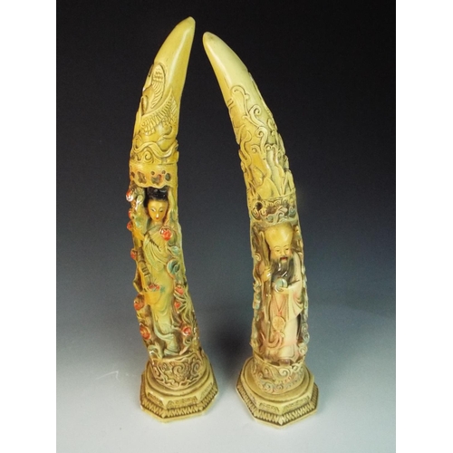 18 - Pair of cast plaster decorated chinese tusks measuring 20 inches tall