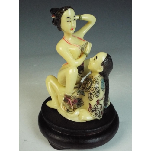 25 - Japanese Okimono resin erotic sculpture on ebonised wooden base. 5 inches tall.