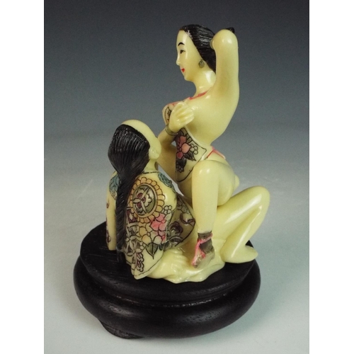 25 - Japanese Okimono resin erotic sculpture on ebonised wooden base. 5 inches tall.