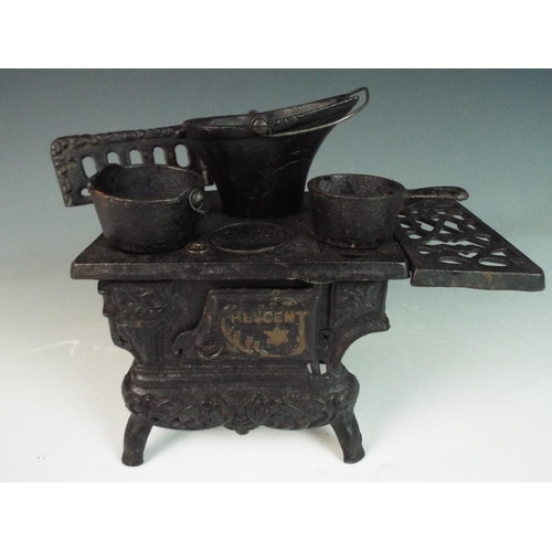 29 - Cast iron scale model of an old coal fired range with metal cooking pans. 7 inches long