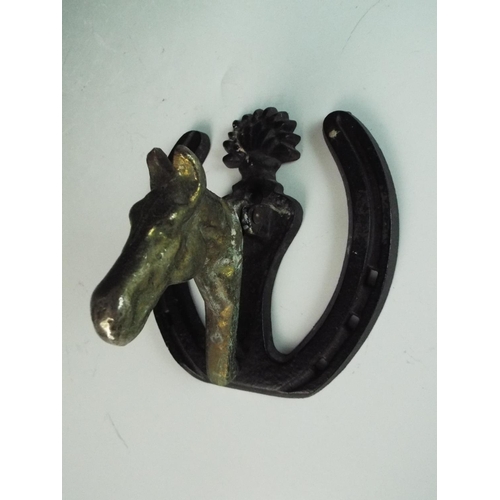 30 - Brass door knocker showing a horsehead on a horseshoe base. 5 inches long