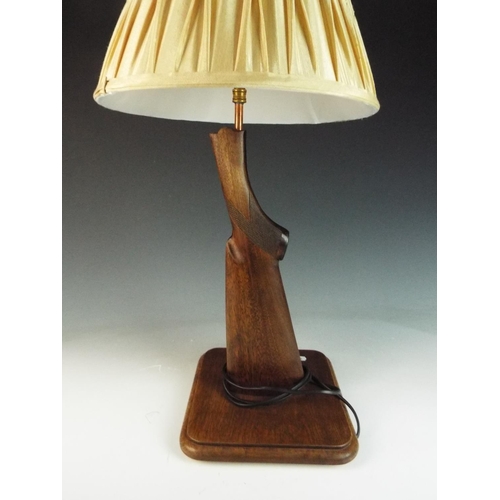 47 - Interesting table lamp made from a shotgun or rifle stock on matching wooden base. Complete with sha... 