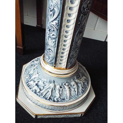 56 - Tall ceramic plant pot stand. Approx 36 inches tall . Decorated with classical figures to base.