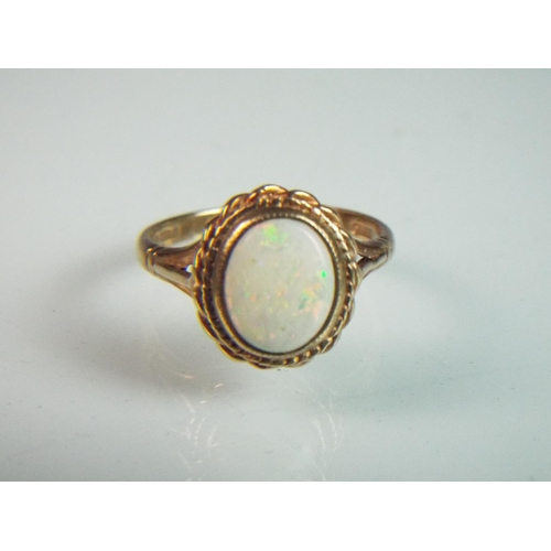 94 - 9ct Opal set ring.  Opal measures 10 x 7 mm with fancy edging to mount,.  'P-5'     3.2g