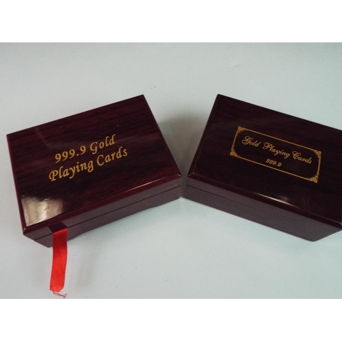 269 - Two lovely rosewood boxes containing packs of gold plated playing cards which appear to be unused.