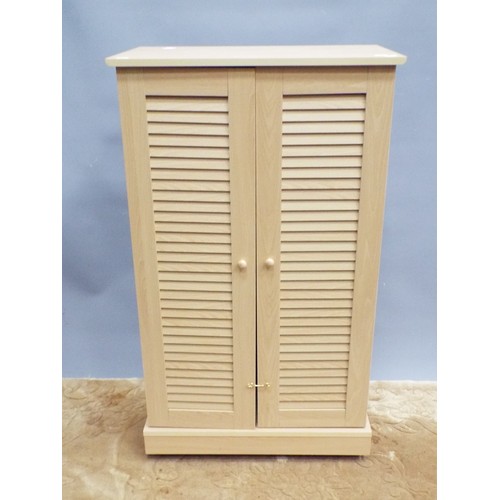 391 - Handy Space saving storage cupboard with louvre front doors. H:41 X W:24 X D:13 inches. Raised on ca... 