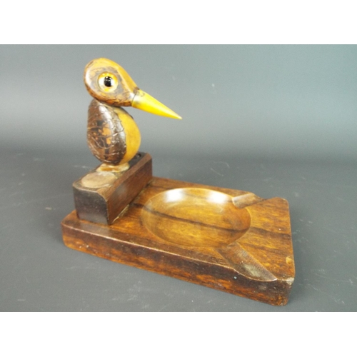 104 - Interesting carved wooden ashtray with bird carved from nuts. Horn beak with glass eyes. 5 inches ta... 