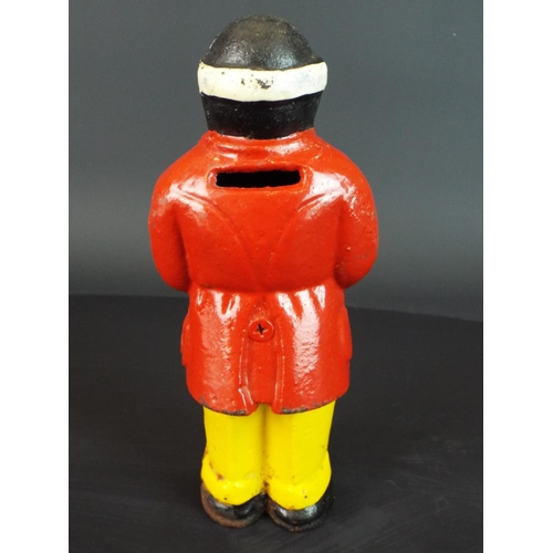 122 - Vintage Cast iron moneybox with painted coat and trousers.  7 inches tall.