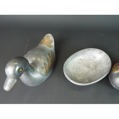 127 - Family of four graduated pewter duck dishes. Longes t 6 inches long.