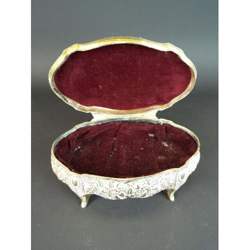 150 - Small spelter jewellery box with embossed decoration. Red velvet to interior. 7 inches long.