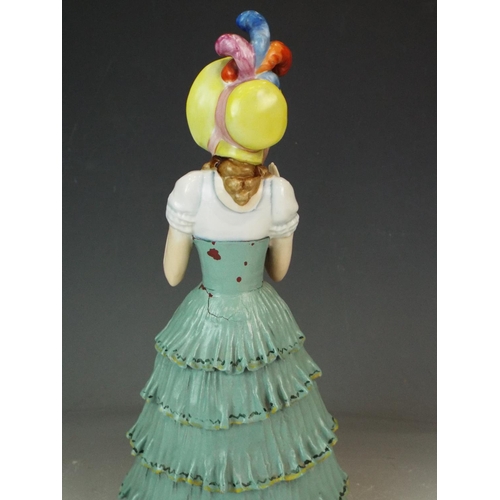 170 - Earthenware glazed figurine of a Period lady with bonnet. 11.5 inches tall. Early 20th Century era.