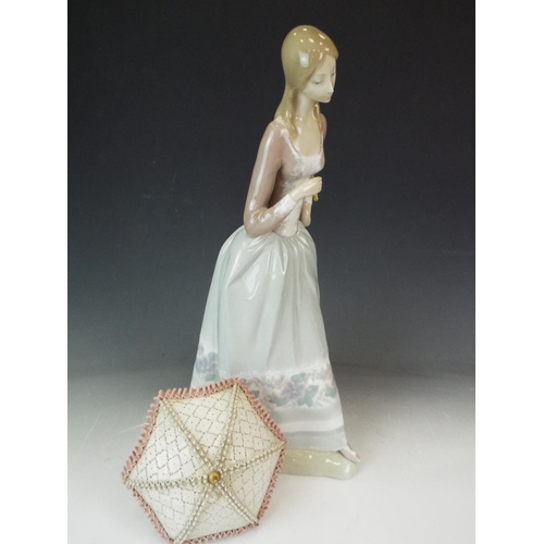 174 - Large Lladro figurine of a lady with parasol, 16 inches tall. (needs repair to parasol handle)