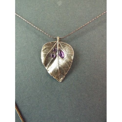 78 - Stone set heart shaped silver pendant plus a leaf shaped pendant set with Purple stones. Each set on... 