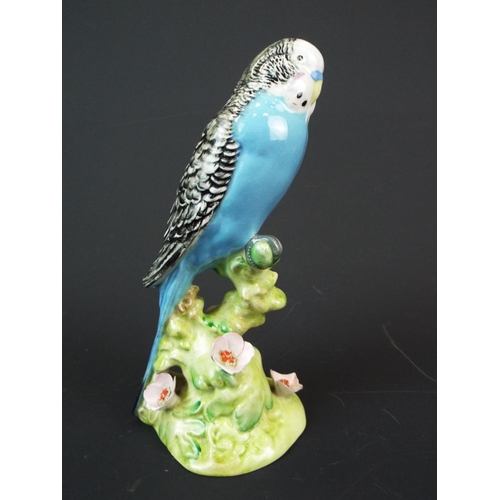 166 - Beswick Budgie, Model number 1214. needs repair to wingtips and flower petals. Worth restoring.