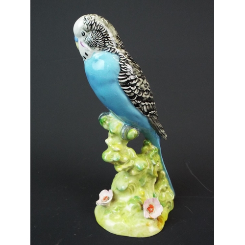 166 - Beswick Budgie, Model number 1214. needs repair to wingtips and flower petals. Worth restoring.