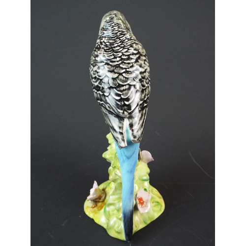 166 - Beswick Budgie, Model number 1214. needs repair to wingtips and flower petals. Worth restoring.